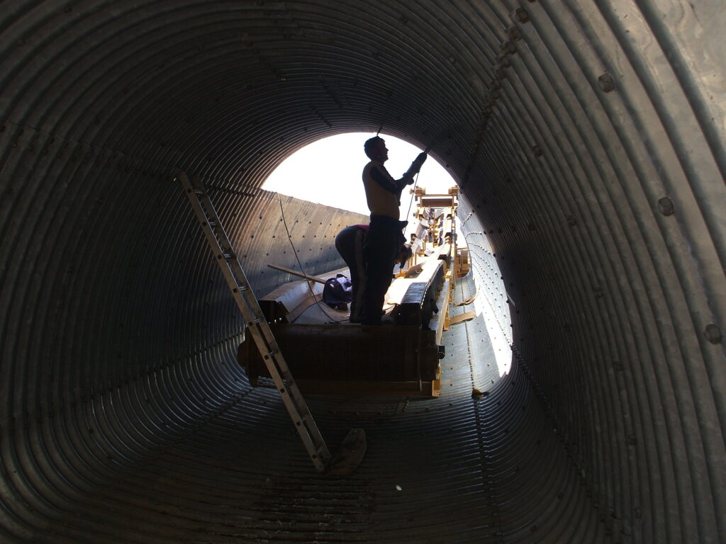 Assembly of tunnel with conveyor belt for crusher feed system